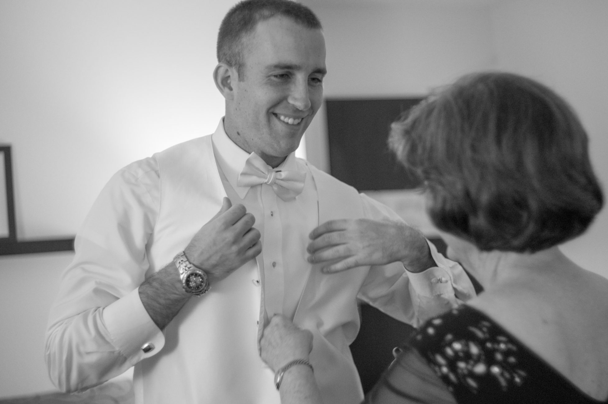groom in bowtie vest tuxedo cufflinks